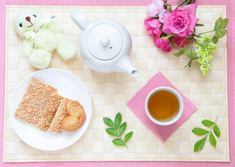 Obraz na płótnie Canvas tea time with cookie, cute bear and beautiful flowers