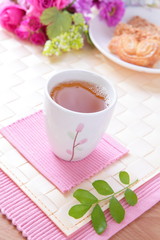 black tea with cookie and beautiful flowers and water drop