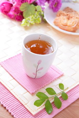 black tea with cookie and beautiful flowers