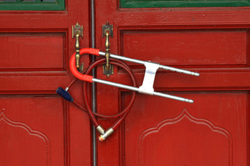 lock hanging on red door