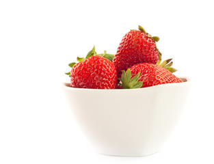 Strawberries in bowl isolated on white background