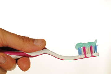 man hand holds toothbrush with toothpaste