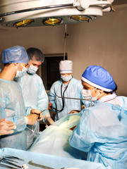 Group of surgeon looking at patient.