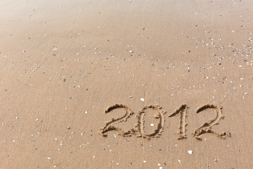 2012 Year written on the beach sand