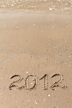 2012 Year written on the beach sand