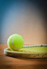 Sports equipment.tennis and racket on wood.