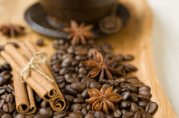coffee grains and spices on wooden background