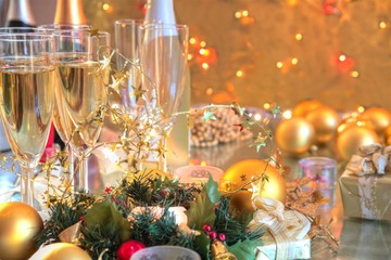 Champagne in glasses,baubles,candle lights.