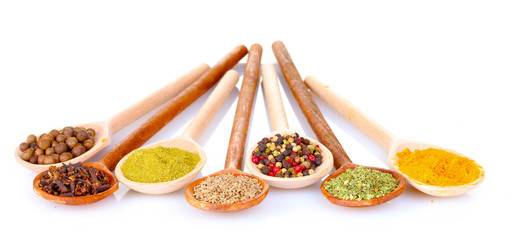 spices in the spoons isolated on white