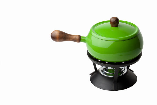 Bright green fondue pot isolated against white background