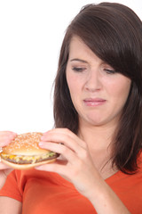 Woman stood holding cheeseburger