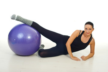 Fototapeta na wymiar Fitness woman working with pilates ball