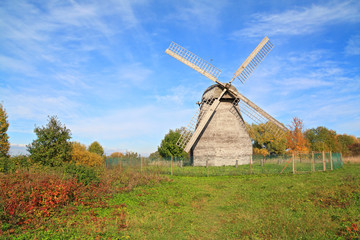 Fototapeta na wymiar aging mill on autumn meadow