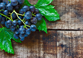 Purple grapes on a rustic wooden table