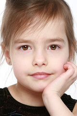 Adorable little girl on white background. Close-up portrait