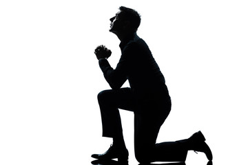silhouette man kneeling praying  full length