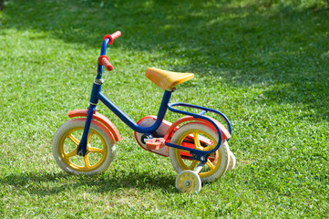A bike for children in a garden.