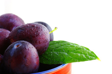 fresh plums over white background