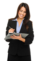 Businesswoman writing into planner