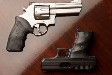 Revolver on surface with 9 mm handgun