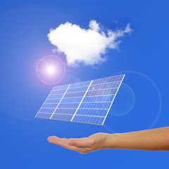 hand with Solar Panel , sunlight and blue sky background
