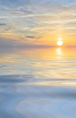 Fototapeta na wymiar bright sunset and clouds at sea background