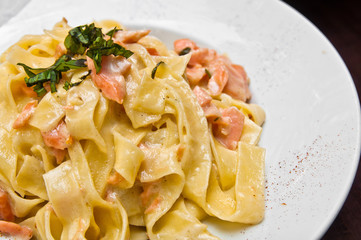 tasty pasta with salmon on a the table