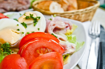 Fresh fruits salad and ham with egg