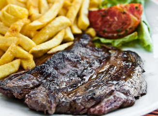 juicy steak beef meat with tomato and french fries