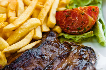 juicy steak beef meat with tomato and french fries