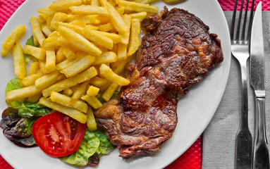 juicy steak beef meat with tomato and french fries