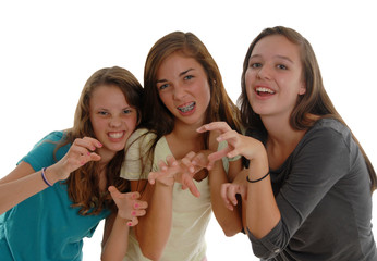 Three teenage girls posing like cats tigers gritting teeth claws