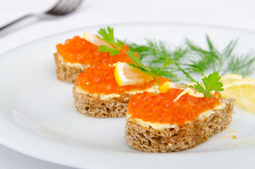 Red caviar served on bread