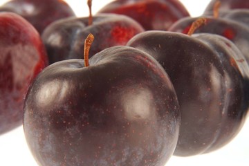 Plums on white background.