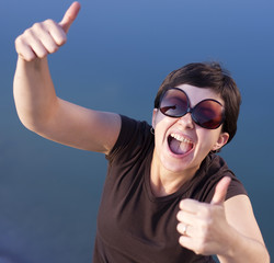 Young brunette girl making thumbs up gesture