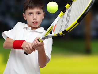 Boy plays tennis