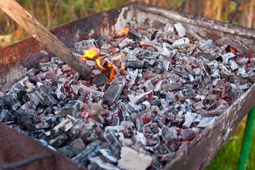 A grill with charcoal and flames