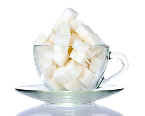 refined sugar in glass cup isolated on white