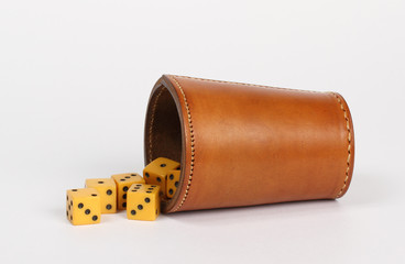leather dice throwing cup and dice on white