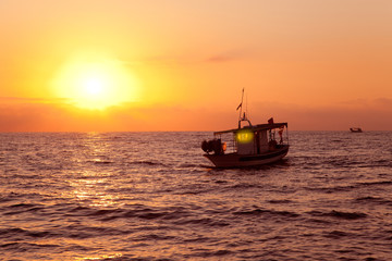 fishing boat in sunrise at Mediterranean sea