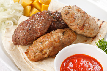 tasty cutlets with sauce and tortilla