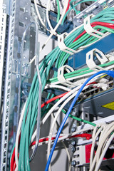 network cables and telecommunication equipment in the rack