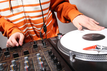Hands of DJ scratching vinyl record