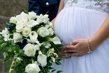 A young couple just married carrying their first child