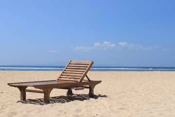 Fototapeta na wymiar Wooden chair on the beach