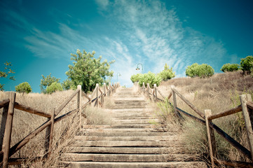 Wood stairs to beuatiful blue sky with clouds