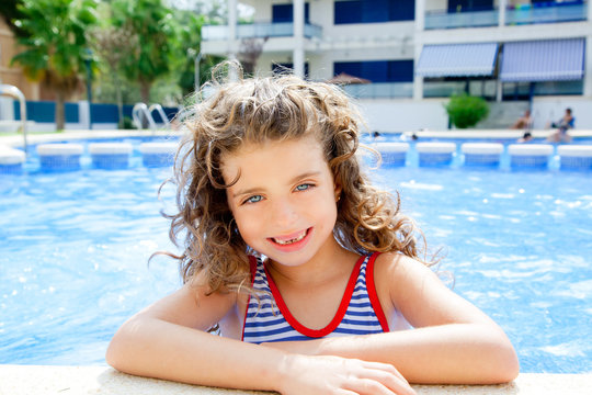 happy kid girl smiling at swimming pool