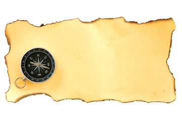 compass on the piece of burnt paper