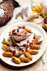 baked pheasant with bacon, pear, raisins on brandy