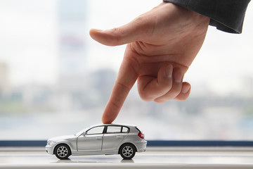 The finger moves the toy car